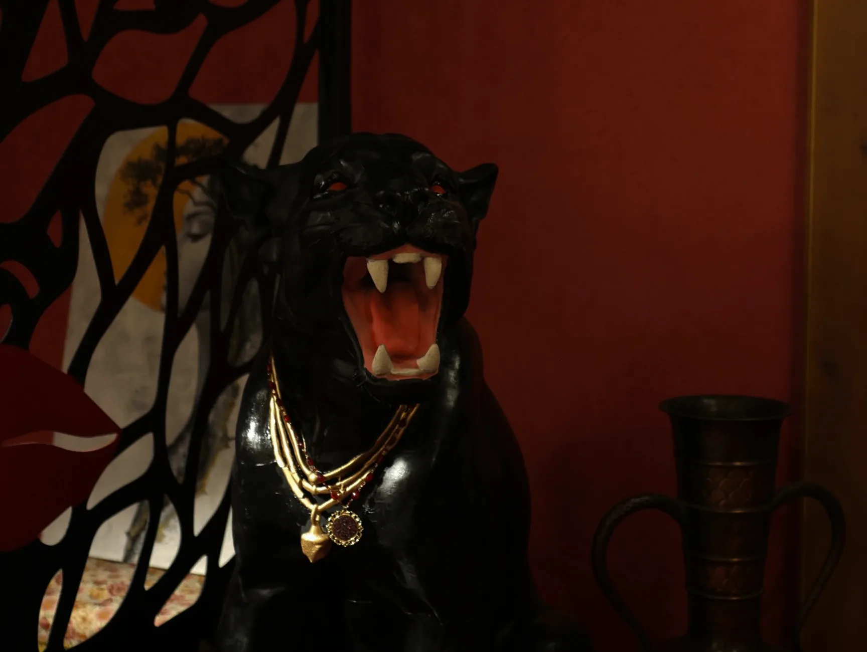 Black panther statue with gold chains inside Obscura cocktail bar, Blloku, Tirana
